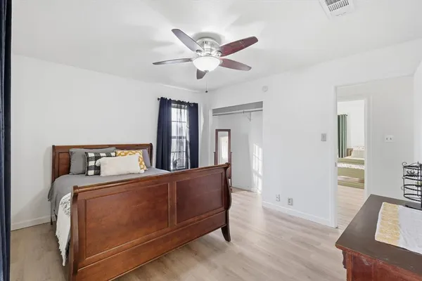 a room with a bed and a chandelier