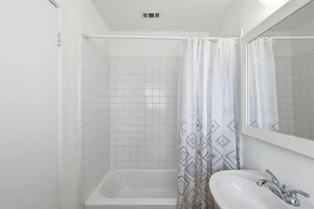 a bathroom with a shower curtain and a sink