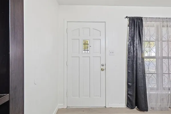 a view of an entryway with wooden floor