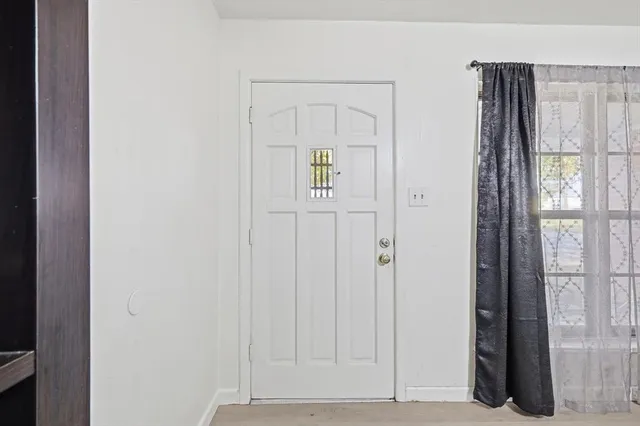 a view of an entryway with wooden floor