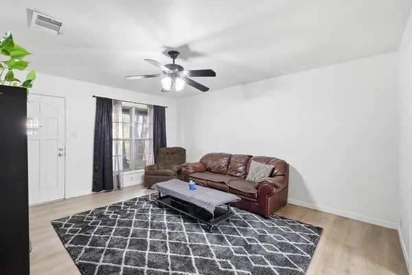 a living room with furniture and a rug