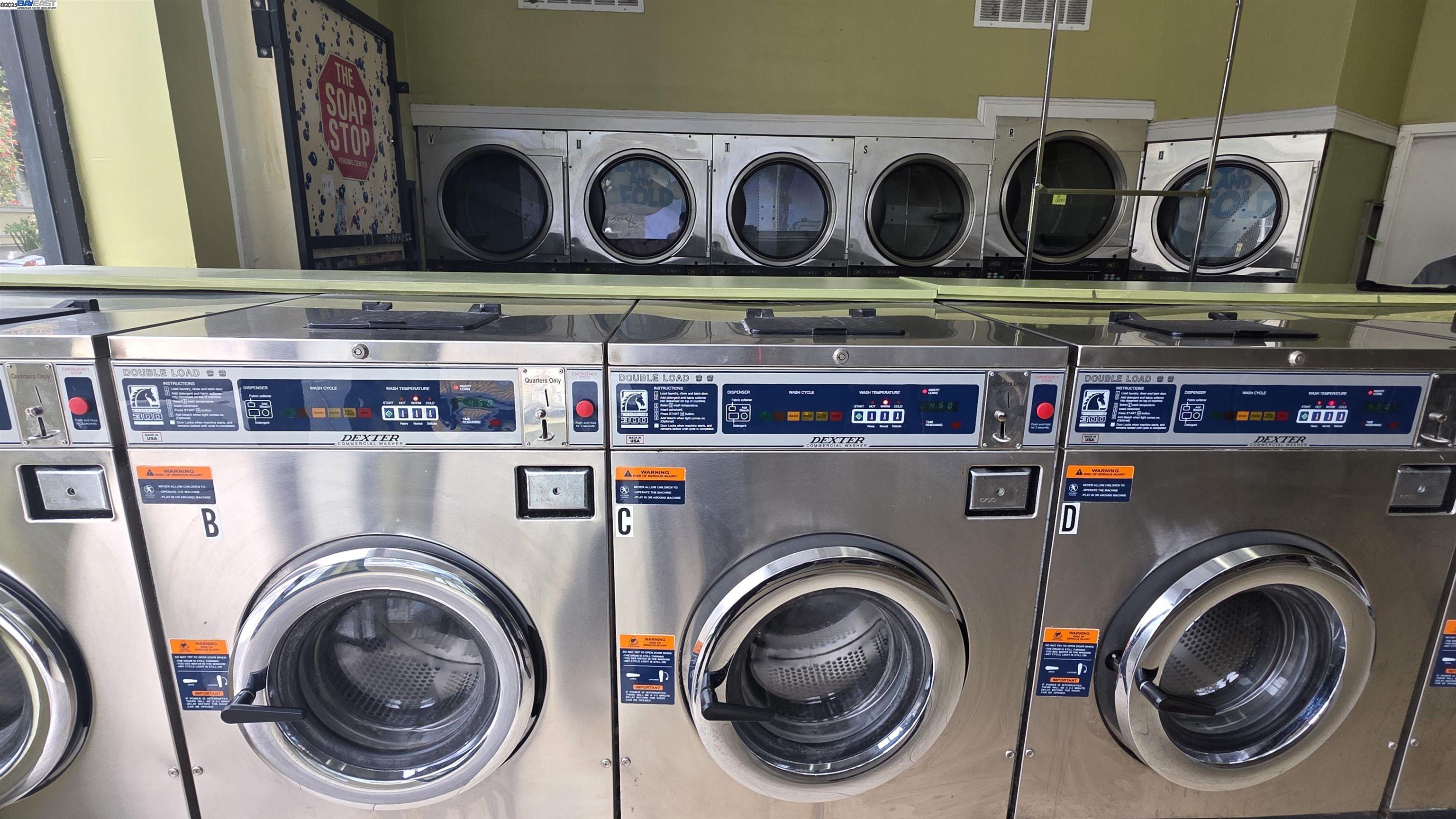 3451 22nd Street San Francisco, CA 94110 - Photo 8 of 10 a utility room with stainless steel appliances and cabinets
