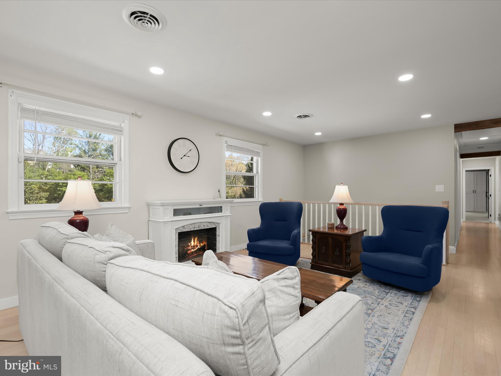 17712 Longdraft Road Gaithersburg, MD 20878 - Photo 16 of 85 a living room with furniture a fireplace and a floor to ceiling window