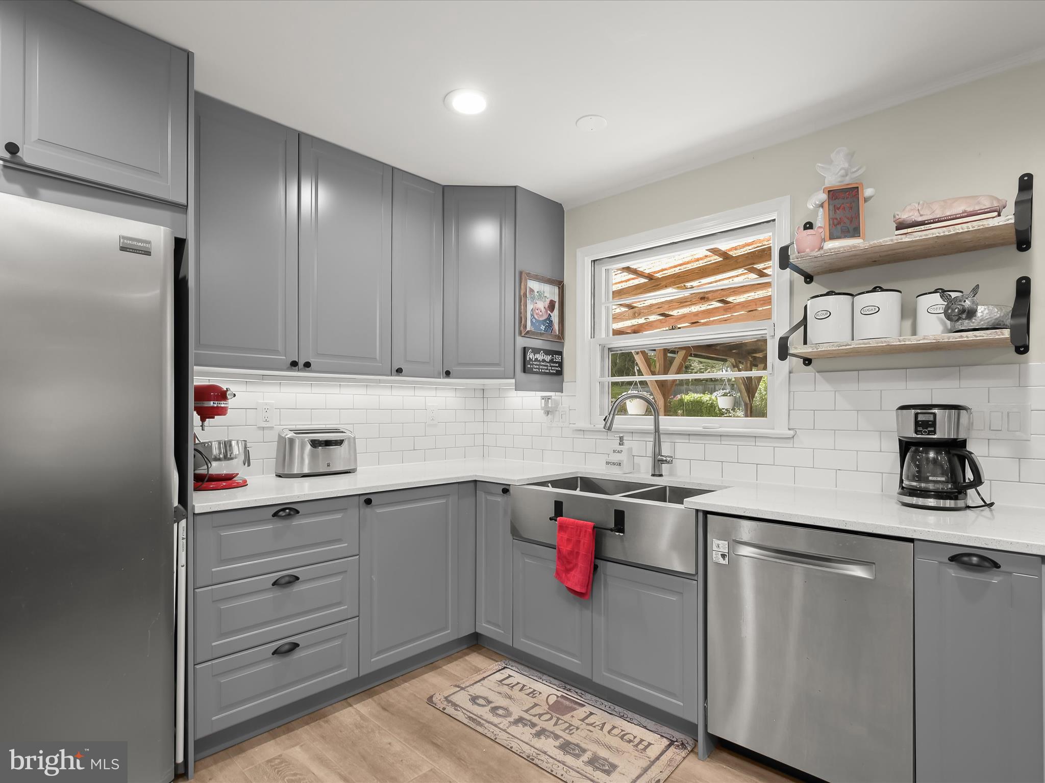 17712 Longdraft Road Gaithersburg, MD 20878 - Photo 19 of 85 a kitchen with a sink cabinets and window