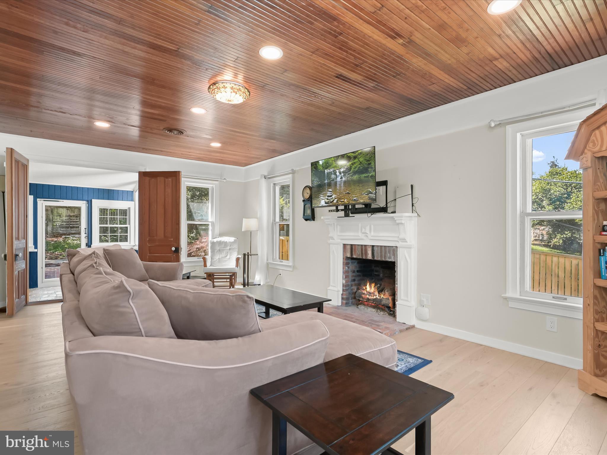 17712 Longdraft Road Gaithersburg, MD 20878 - Photo 29 of 85 a living room with furniture a fireplace and a table
