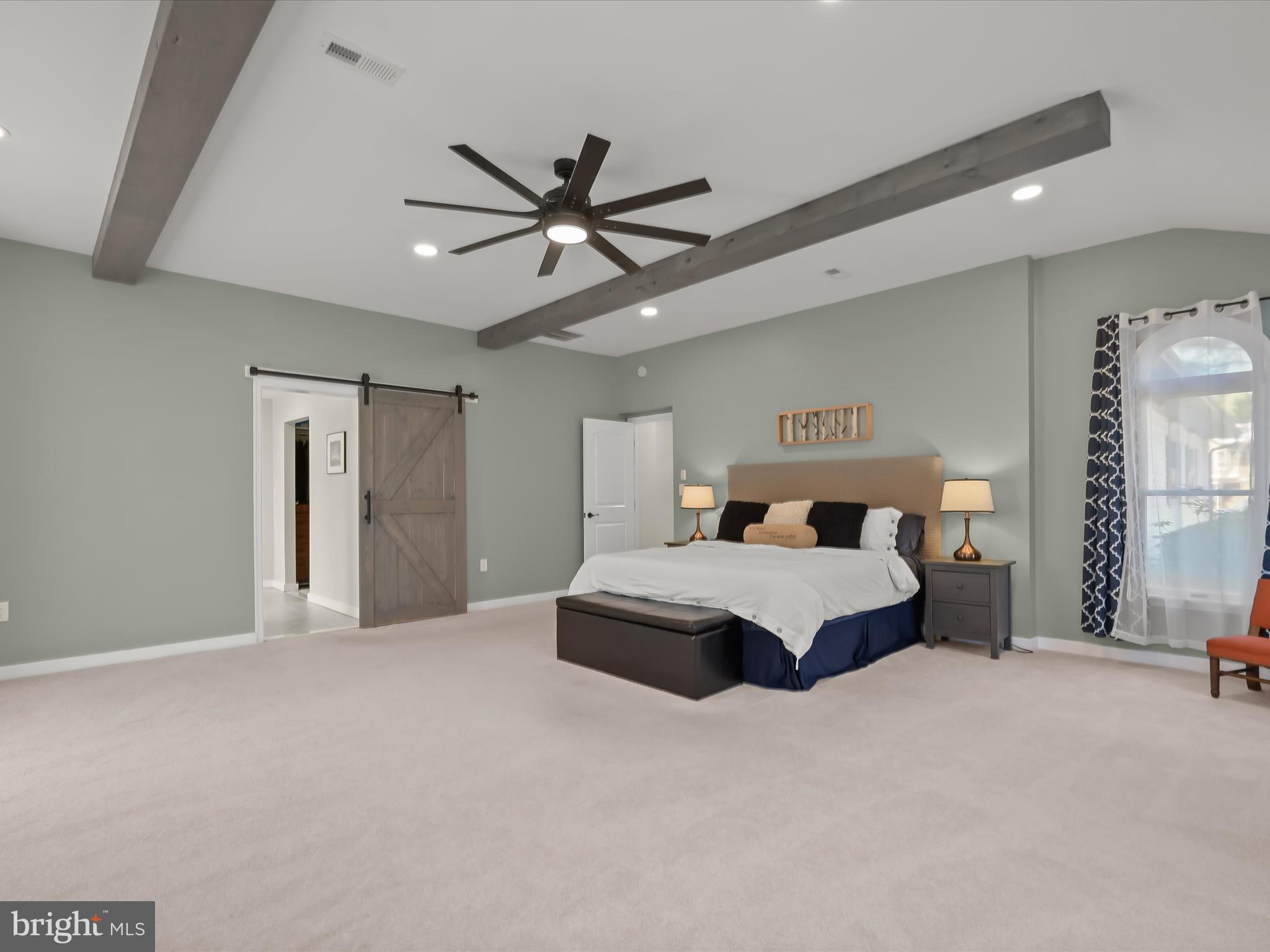 17712 Longdraft Road Gaithersburg, MD 20878 - Photo 38 of 85 a spacious bedroom with a bed and a ceiling fan