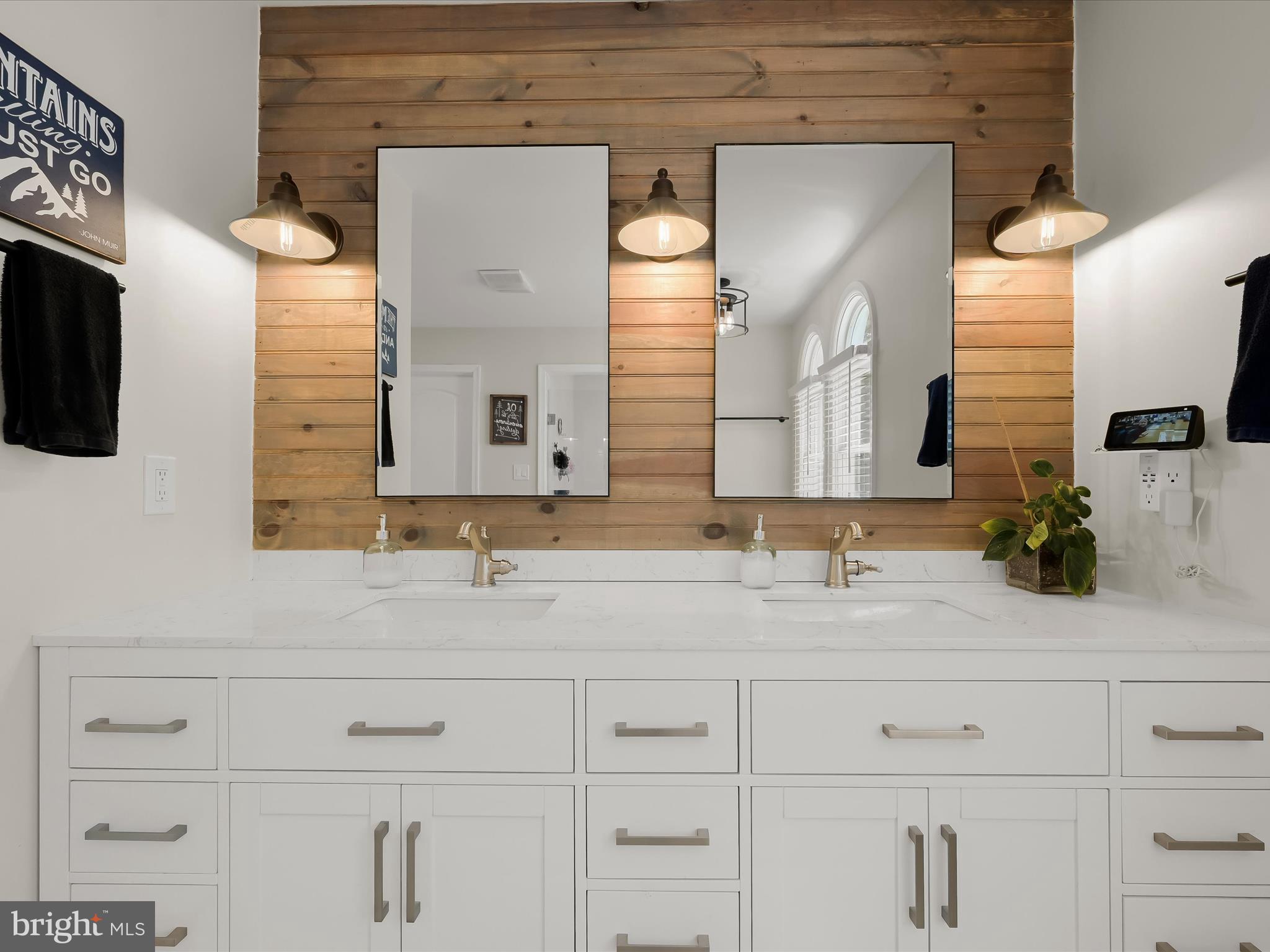 17712 Longdraft Road Gaithersburg, MD 20878 - Photo 43 of 85 a bathroom with a sink and a mirror