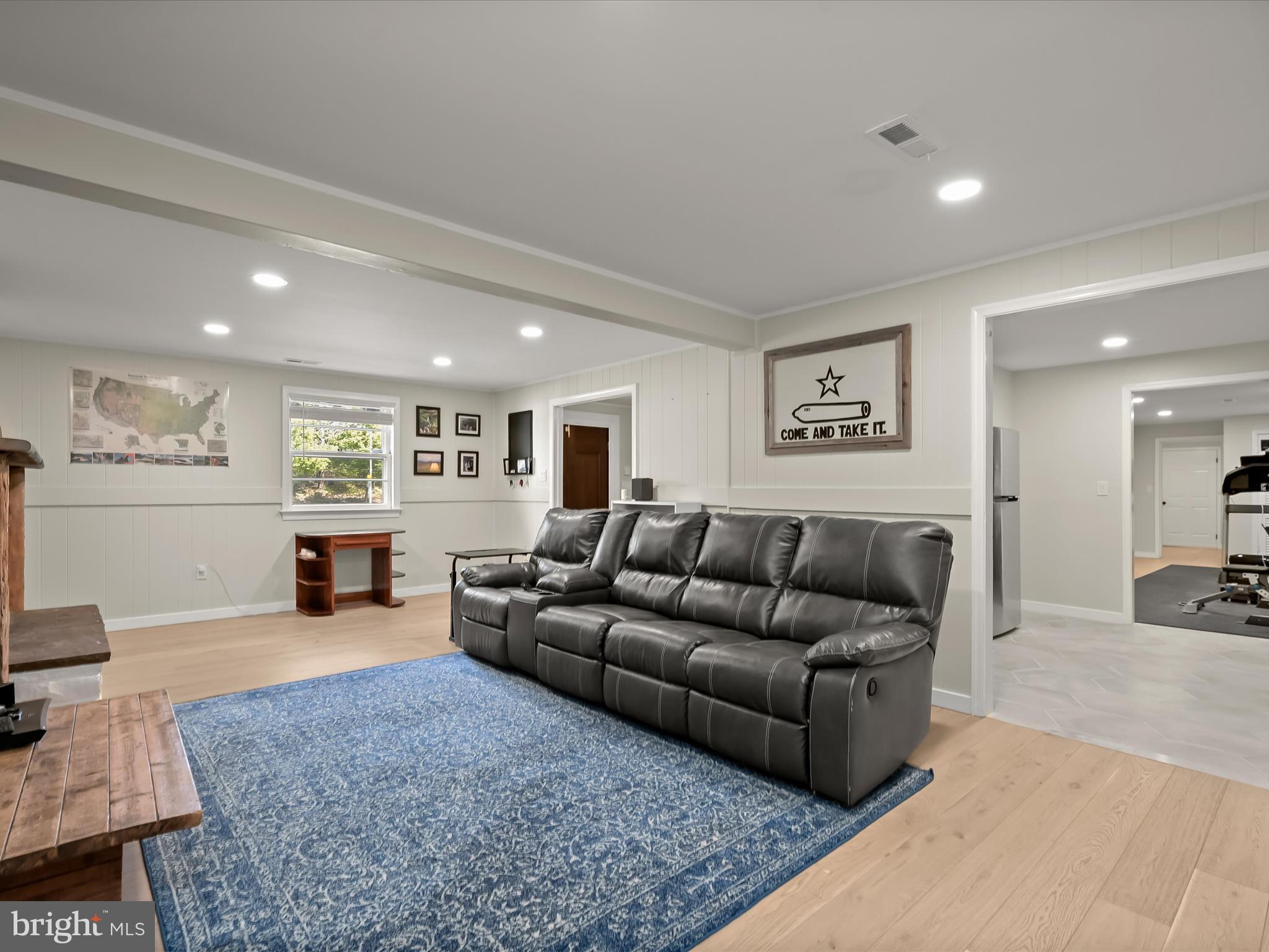 17712 Longdraft Road Gaithersburg, MD 20878 - Photo 57 of 85 a living room with furniture and a wooden floor