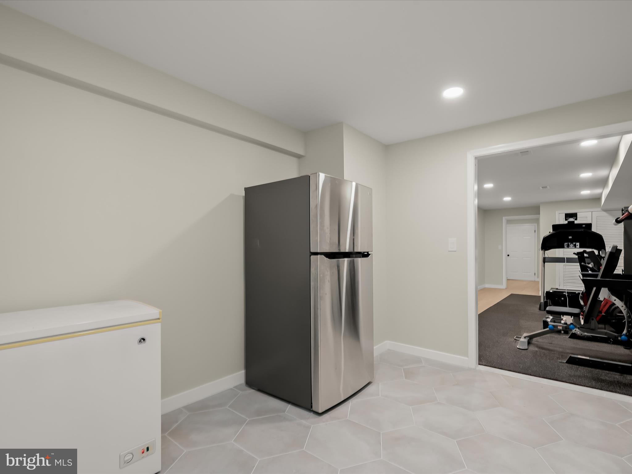 17712 Longdraft Road Gaithersburg, MD 20878 - Photo 59 of 85 a view of a kitchen with a refrigerator and a washing machine