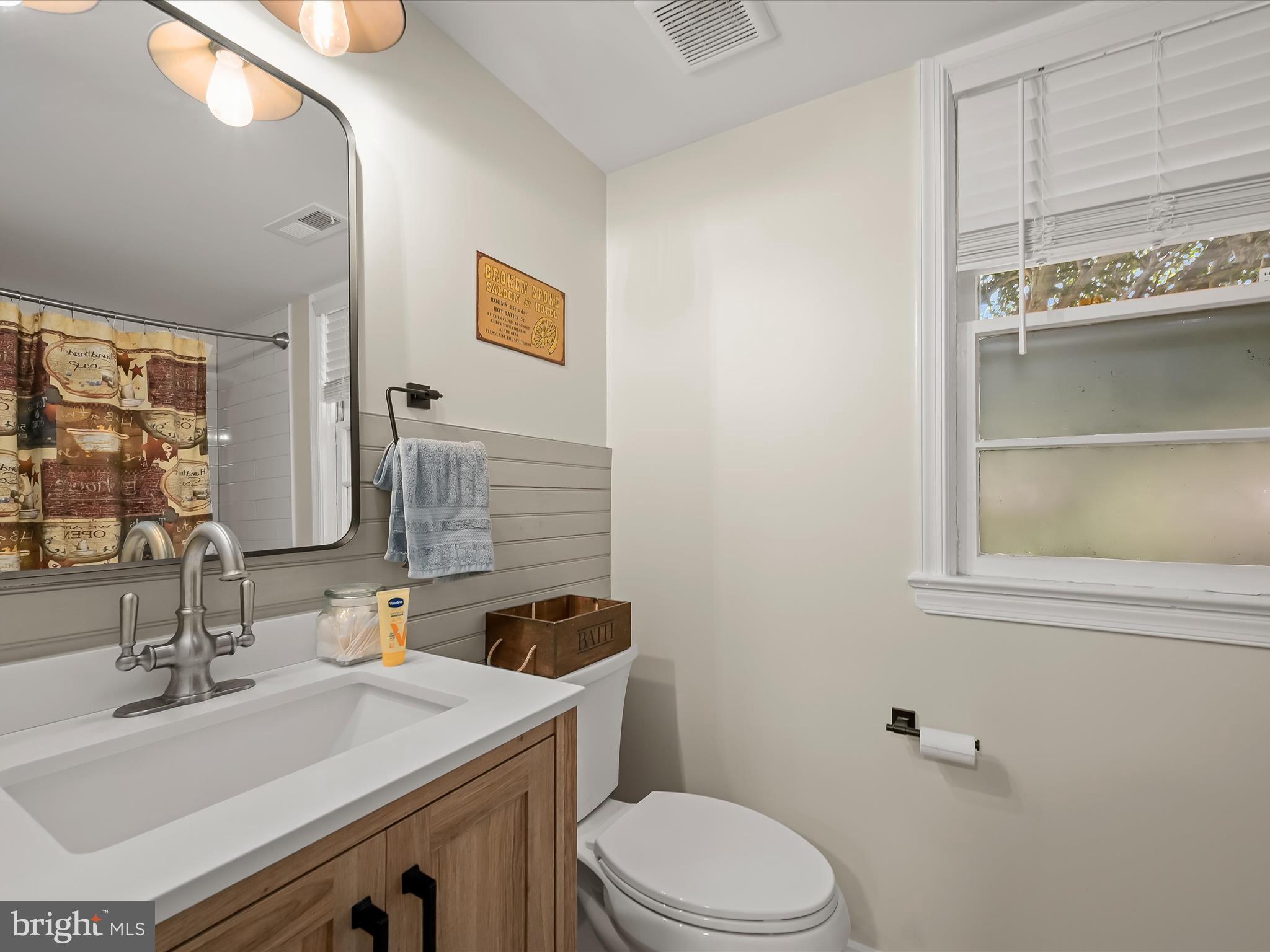 17712 Longdraft Road Gaithersburg, MD 20878 - Photo 68 of 85 a bathroom with a sink toilet and mirror