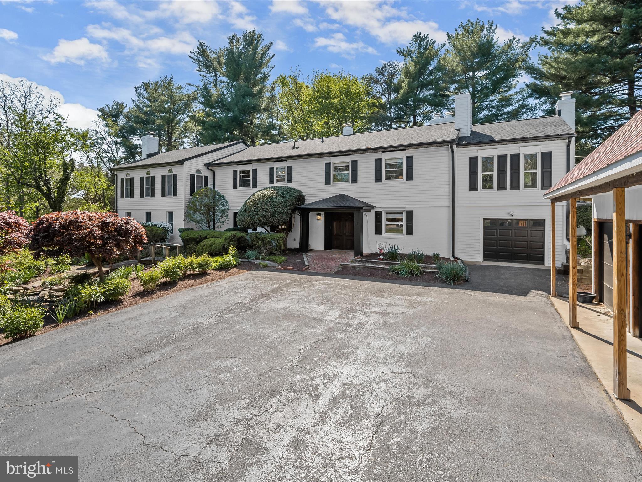 17712 Longdraft Road Gaithersburg, MD 20878 - Photo 9 of 85 a front view of a house with a yard and outdoor seating