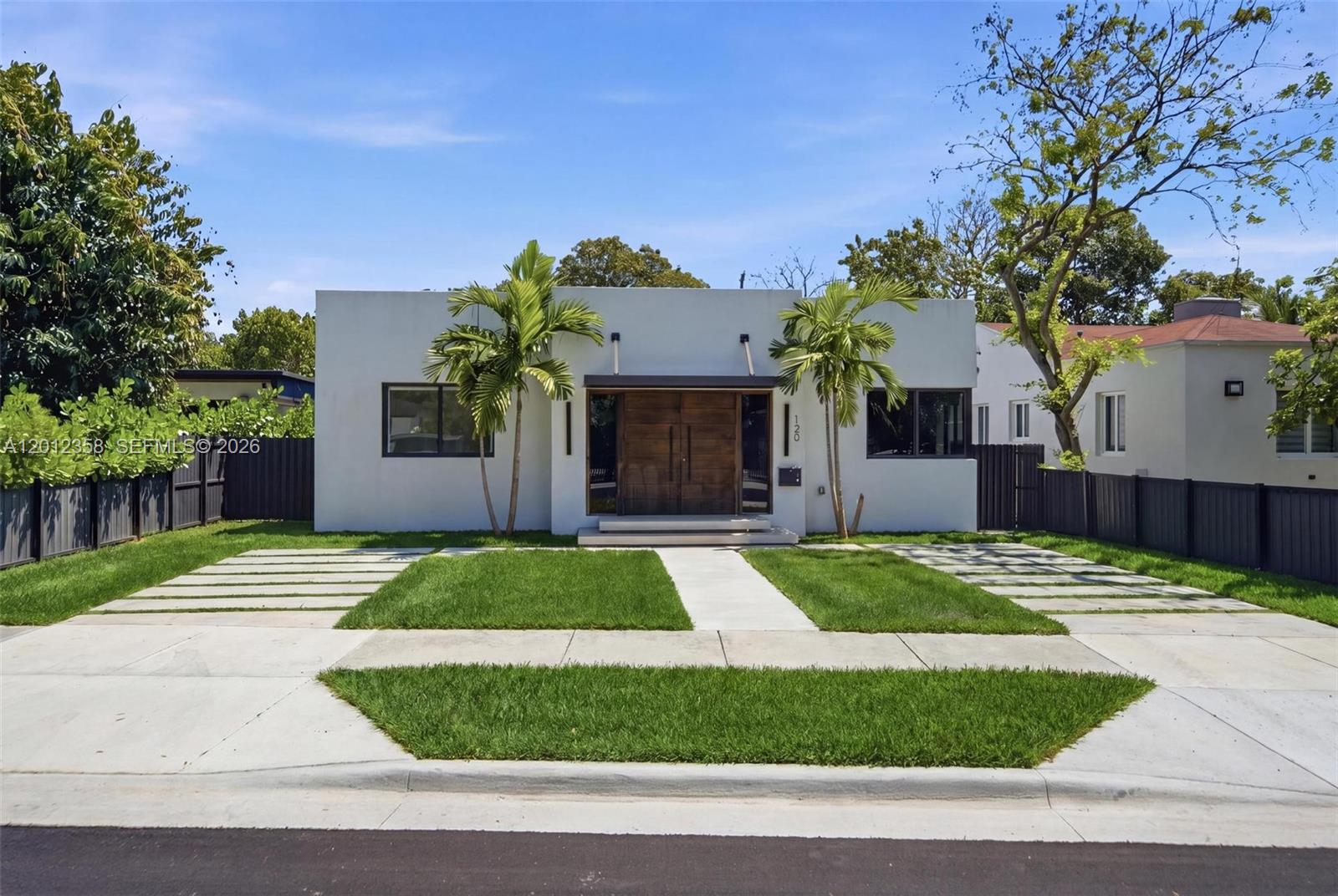 120 Northeast 49th Street Miami, FL 33137 - Photo 1 of 34 a front view of a house with a yard and garage