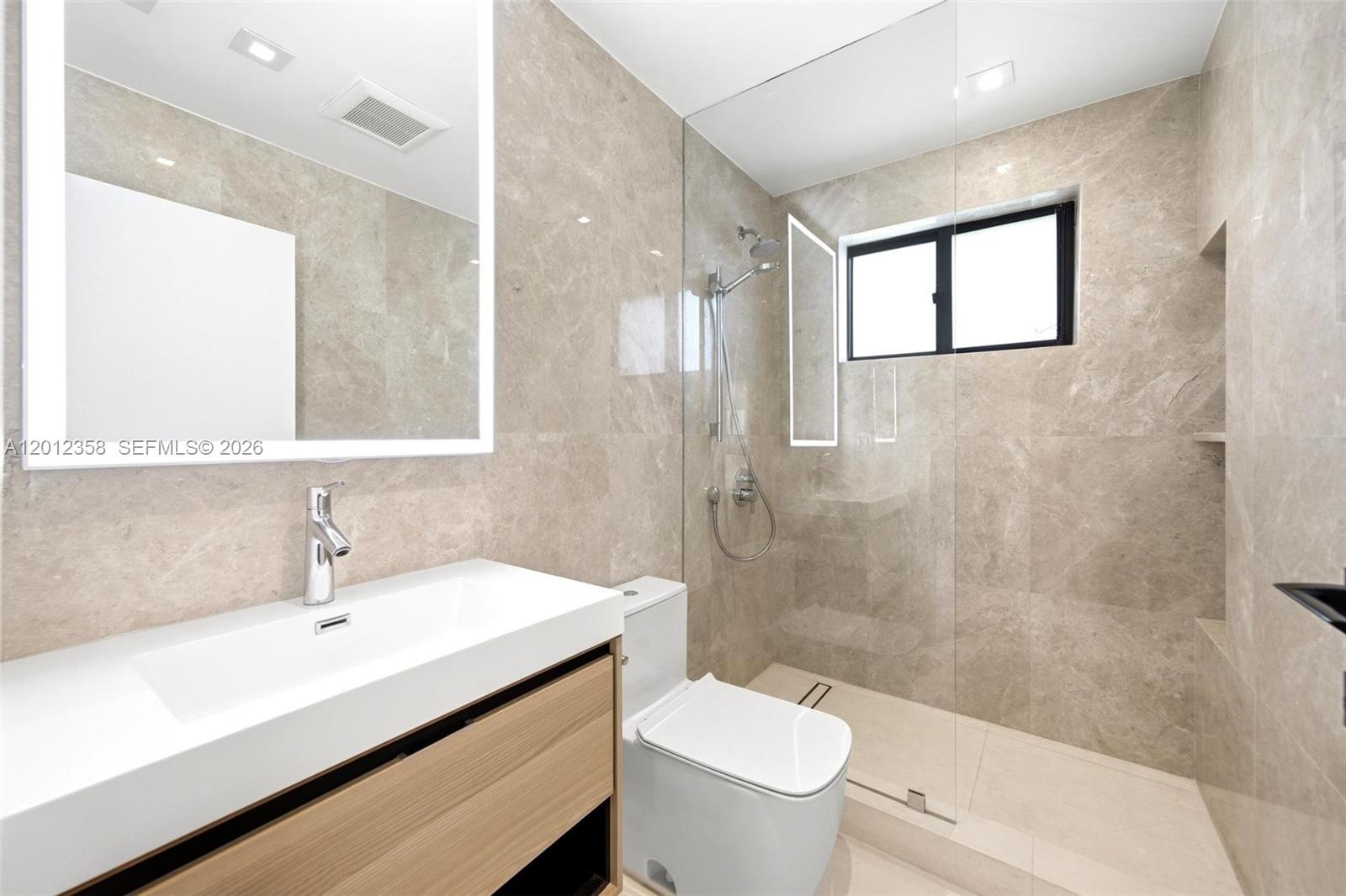 120 Northeast 49th Street Miami, FL 33137 - Photo 27 of 34 a bathroom with a sink toilet a mirror and shower