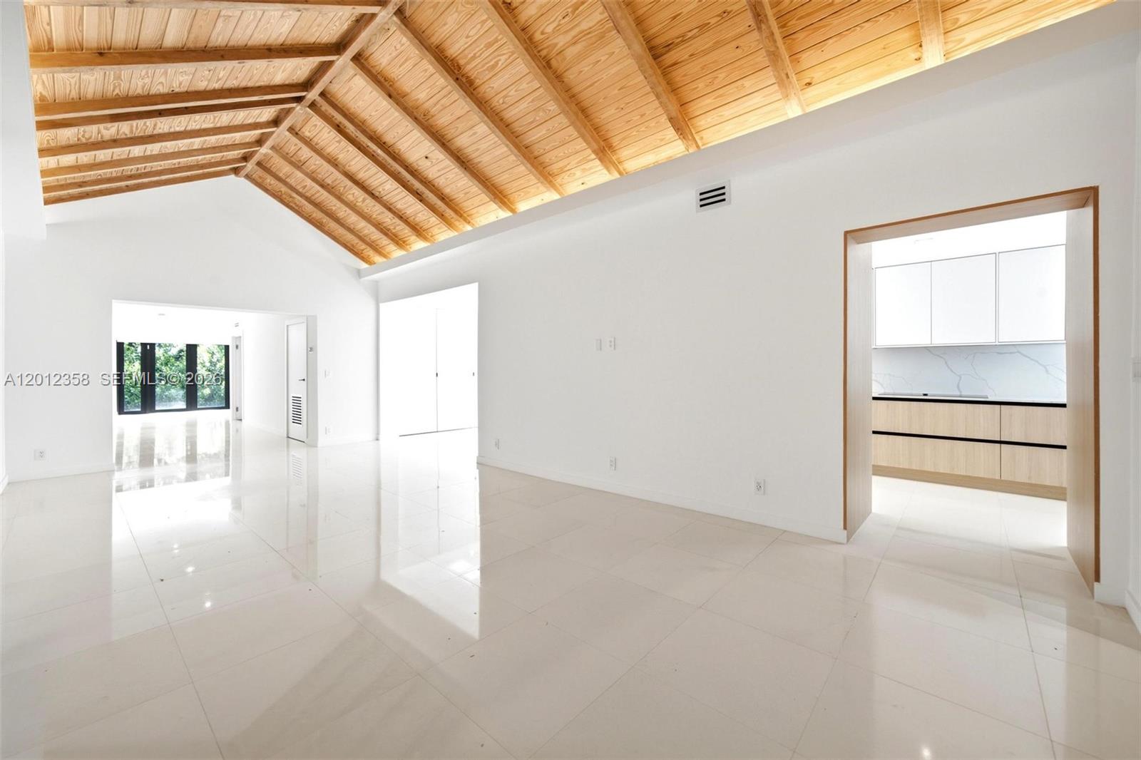 120 Northeast 49th Street Miami, FL 33137 - Photo 7 of 34 a view of a room with wooden floor and windows