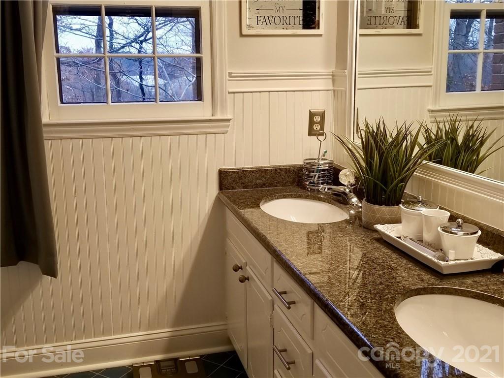 7900 Quail Hill Road Charlotte, NC 28210 - Photo 14 of 28 a bathroom with a granite countertop sink and a mirror