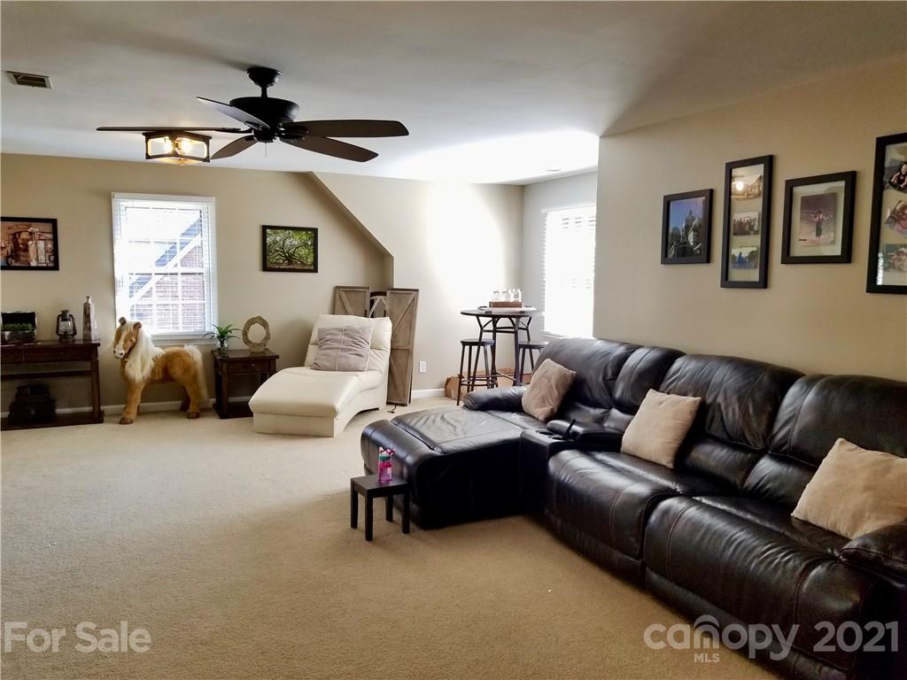 7900 Quail Hill Road Charlotte, NC 28210 - Photo 16 of 28 a living room with furniture and a ceiling fan