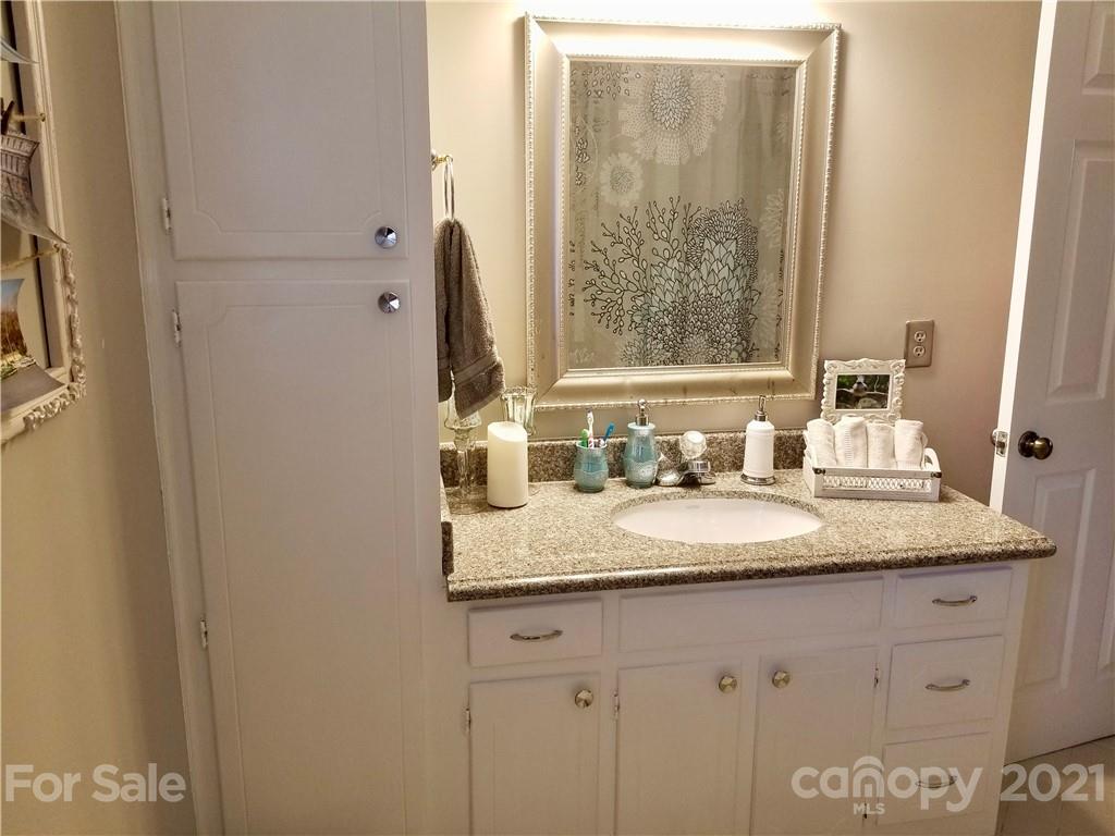7900 Quail Hill Road Charlotte, NC 28210 - Photo 20 of 28 a bathroom with a granite countertop sink and a mirror