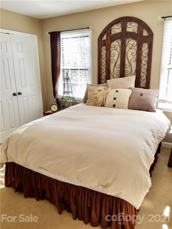 7900 Quail Hill Road Charlotte, NC 28210 - Photo 21 of 28 a large bed sitting in a bedroom next to a window