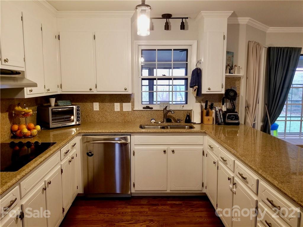 7900 Quail Hill Road Charlotte, NC 28210 - Photo 7 of 28 a kitchen with stainless steel appliances granite countertop a stove a sink and white cabinets