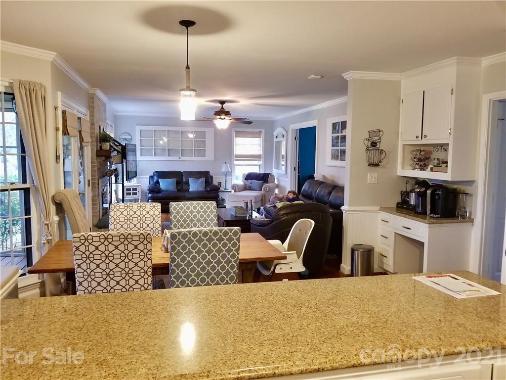 7900 Quail Hill Road Charlotte, NC 28210 - Photo 9 of 28 a living room with furniture a flat screen tv and a chandelier