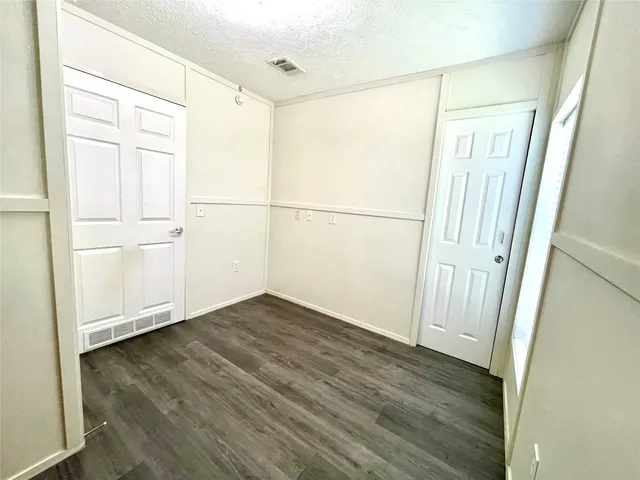 a view of a small space with wooden floor