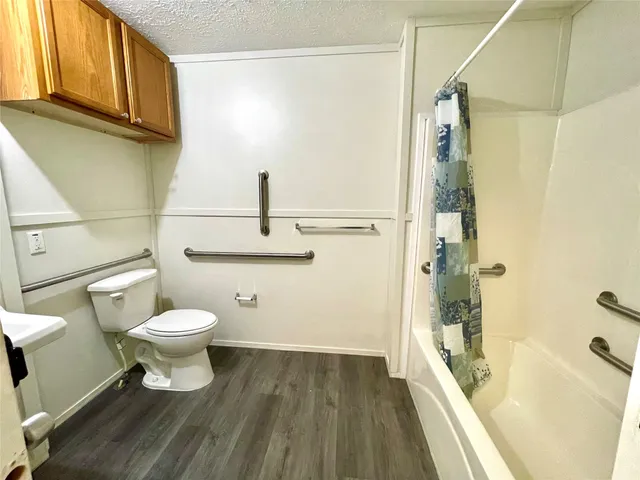 a bathroom with a toilet and a shower