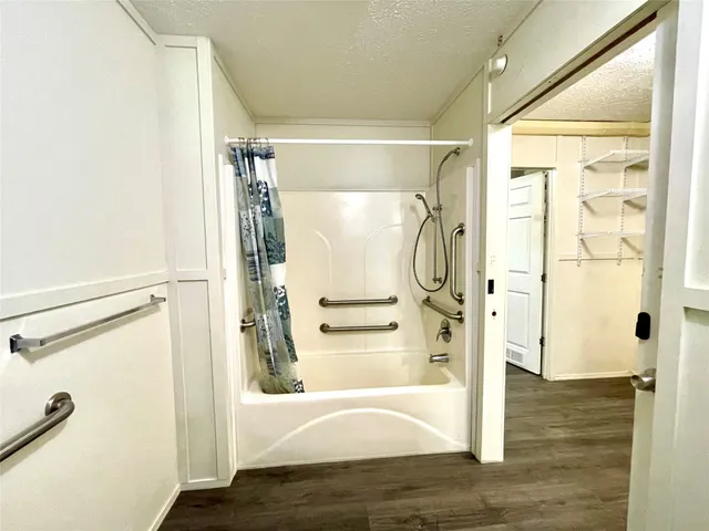 a view of walk in closet with window and wooden floor
