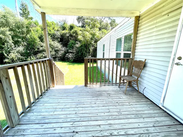a view of a balcony with wooden floor