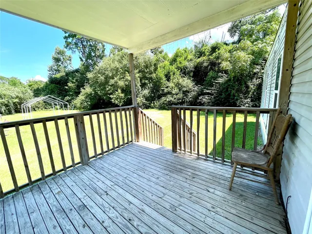 a view of balcony with wooden floor and seating space