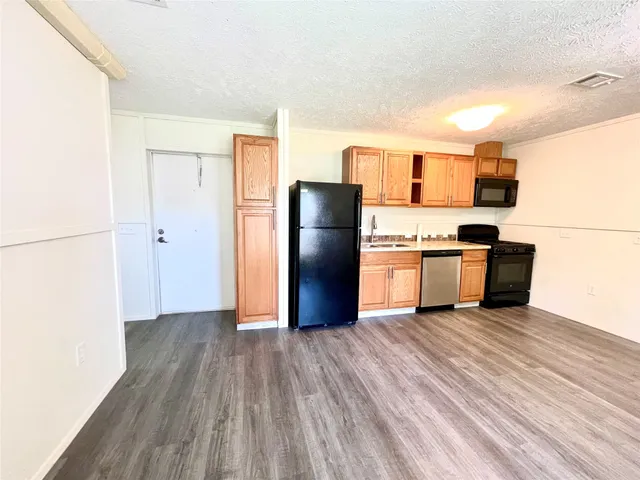 a kitchen with stainless steel appliances a refrigerator and a stove
