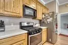 a kitchen with stainless steel appliances granite countertop a sink and a stove
