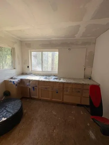 a kitchen with granite countertop a sink and a stove