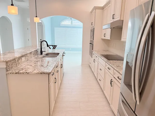 a bathroom with a granite countertop sink a toilet and shower