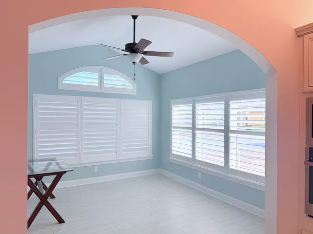 a view of a room with windows and cabinet
