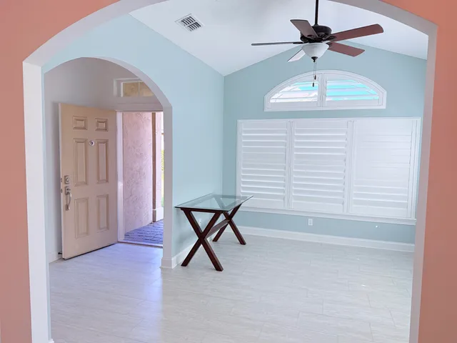 a view of a livingroom with a furniture and chandelier fan