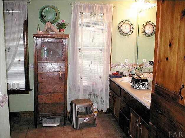 6959 Martin Road Milton, FL 32570 - Photo 7 of 11 a bathroom with a granite countertop sink and a mirror