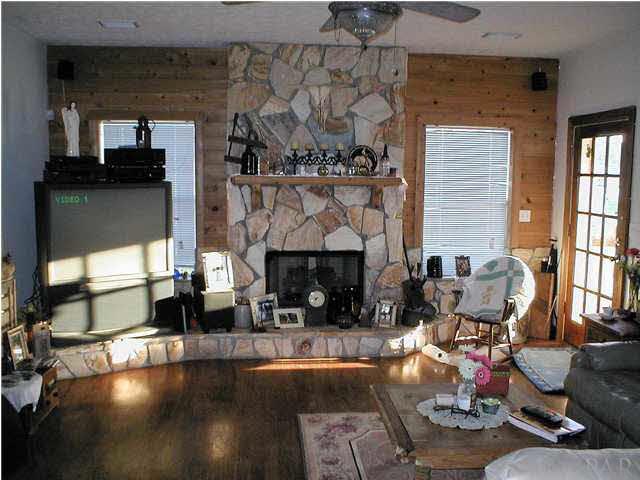 6959 Martin Road Milton, FL 32570 - Photo 8 of 11 a living room with furniture and a fireplace
