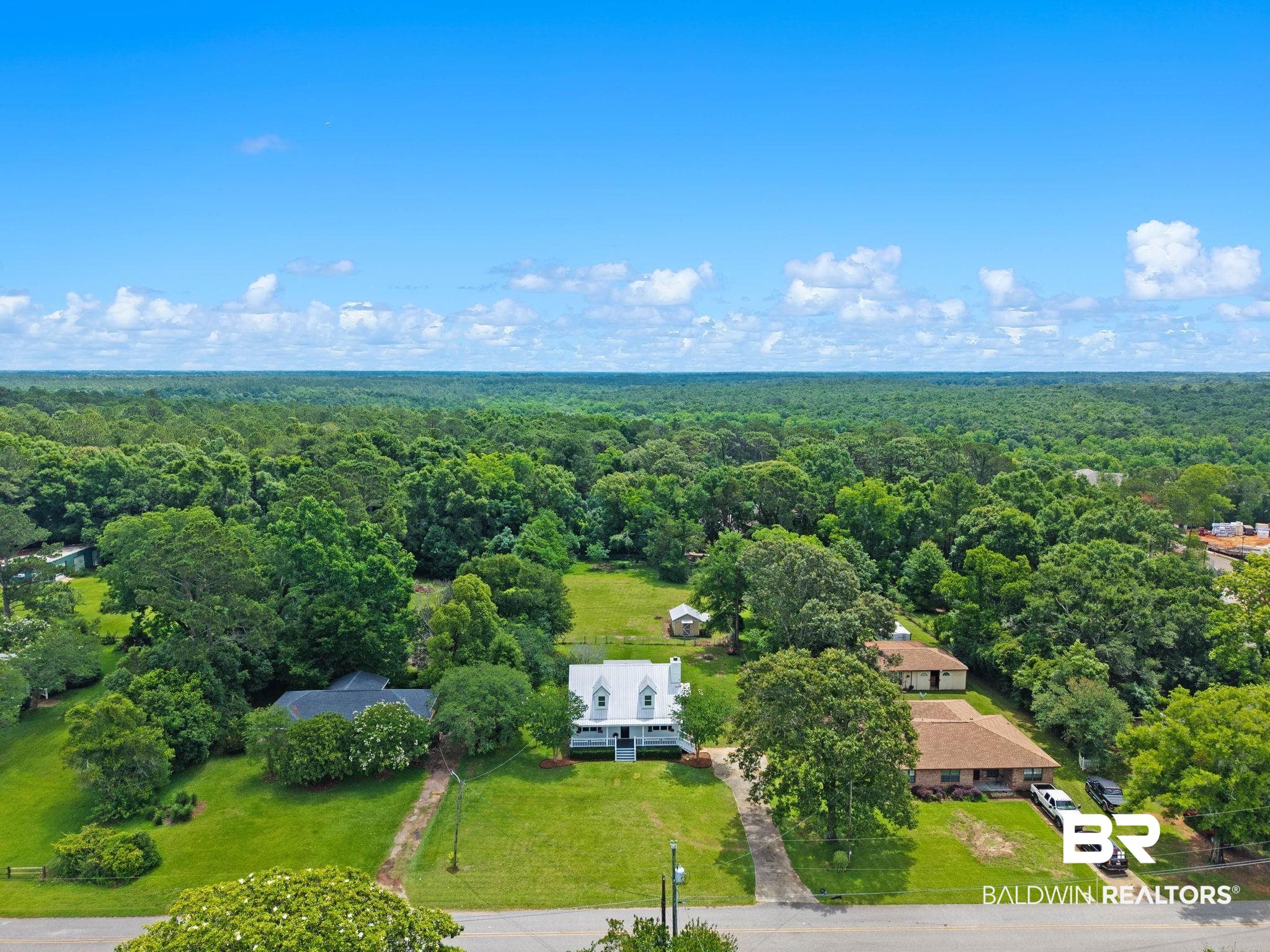 22810 High Ridge Road Fairhope, AL 36532 - Photo 63 of 78 Aerial perspective showcasing a white residence with a gabled roof and covered front porch