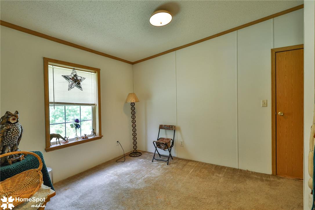 3795 Rhoades Road Kempton, PA 19529 - Photo 19 of 42 A well-lit interior room with neutral carpeting and a window offering a glimpse of the outdoors.