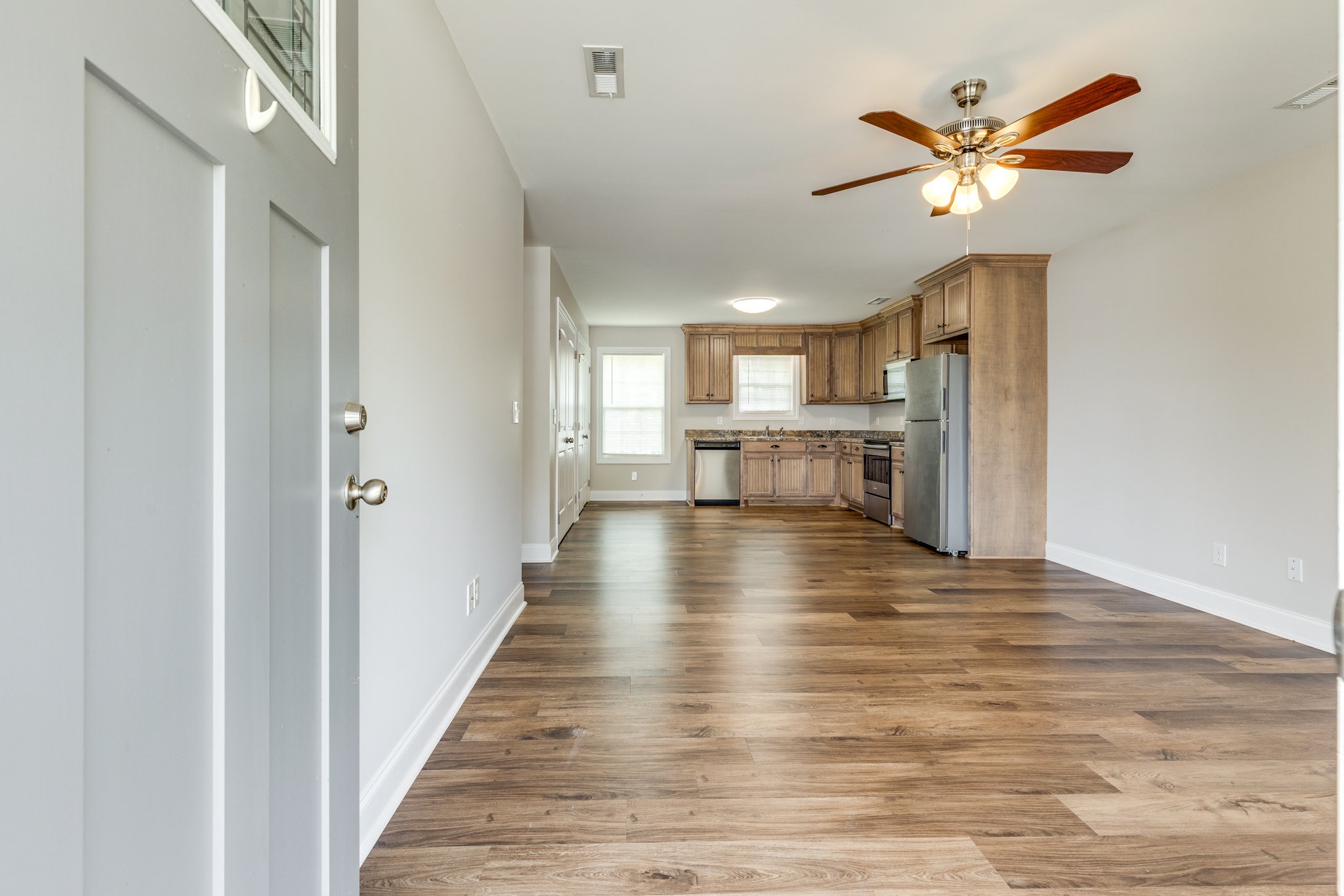 143 Ragsdale Lane Pulaski, TN 38478 - Photo 5 of 22 a view of a livingroom with a flat screen tv wooden floor and a ceiling fan