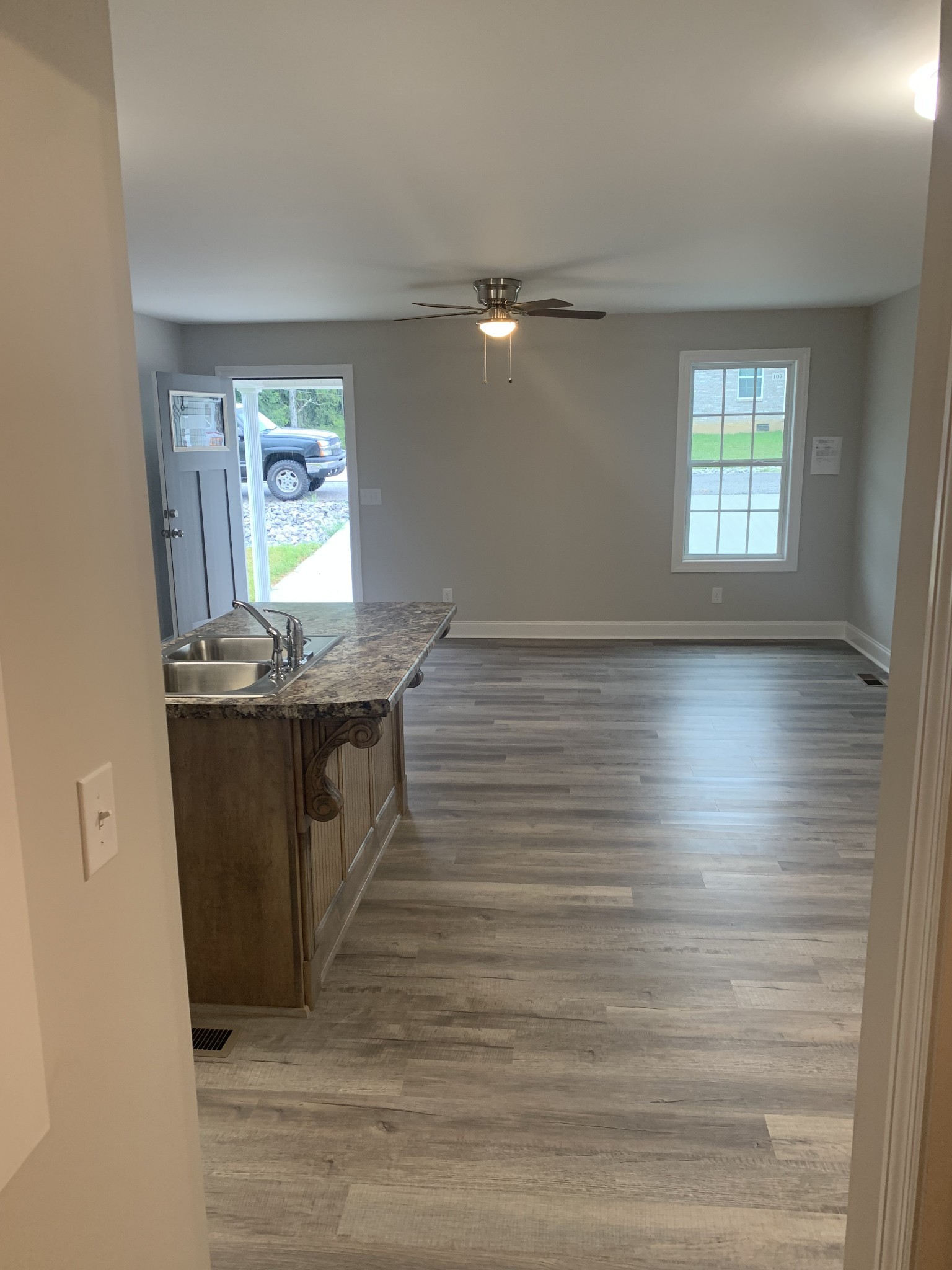143 Ragsdale Lane Pulaski, TN 38478 - Photo 5 of 7 a kitchen with stainless steel appliances granite countertop a sink window and wooden floor