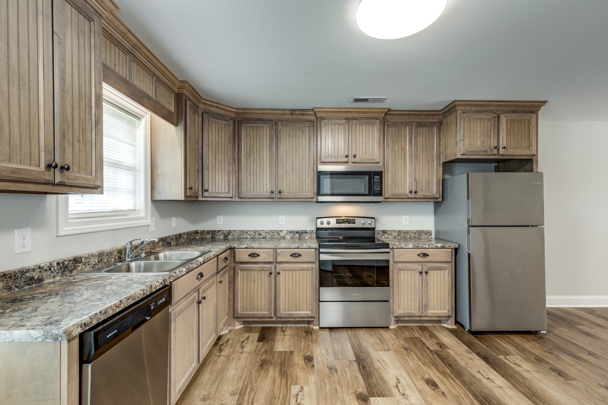 143 Ragsdale Lane Pulaski, TN 38478 - Photo 9 of 22 a kitchen with a sink a stove and refrigerator
