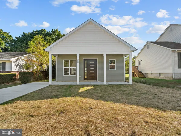 a front view of a house with a garden