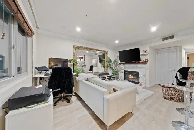 a living room with furniture a fireplace and a flat screen tv
