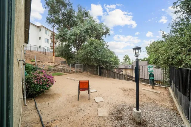 a backyard of a house with table and chairs
