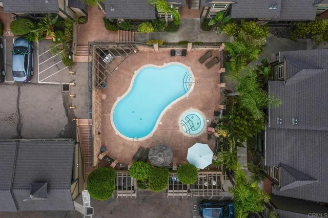 an aerial view of a swimming pool patio outdoor seating and yard