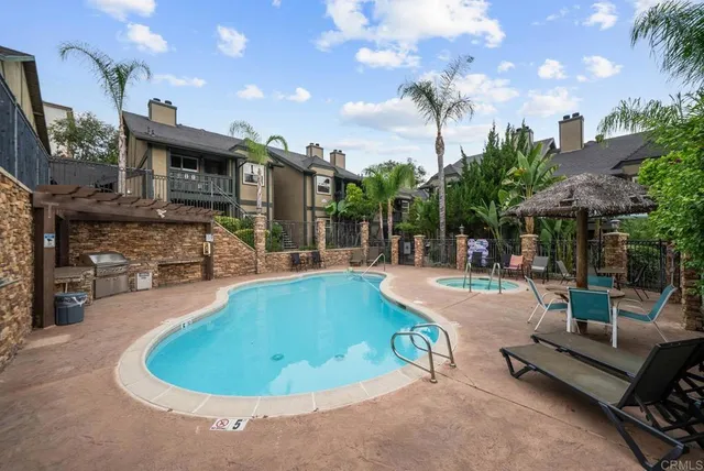 a view of a swimming pool with sitting area