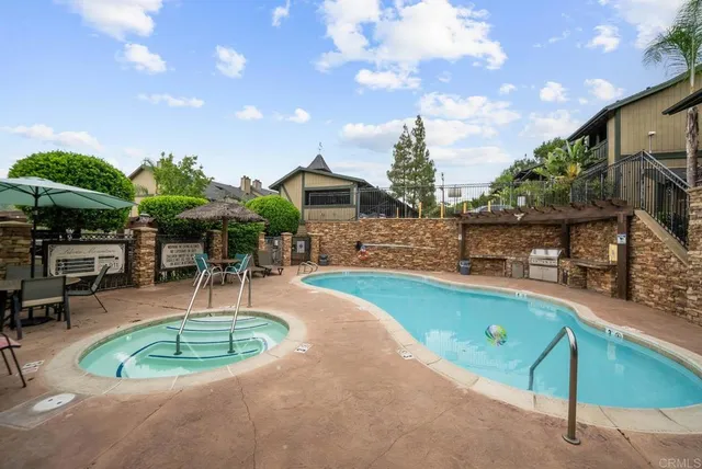 a swimming pool with outdoor seating yard and barbeque oven