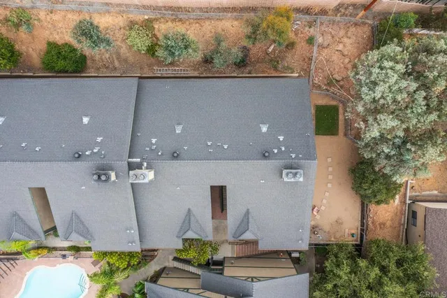 an aerial view of a house with a yard and outdoor seating