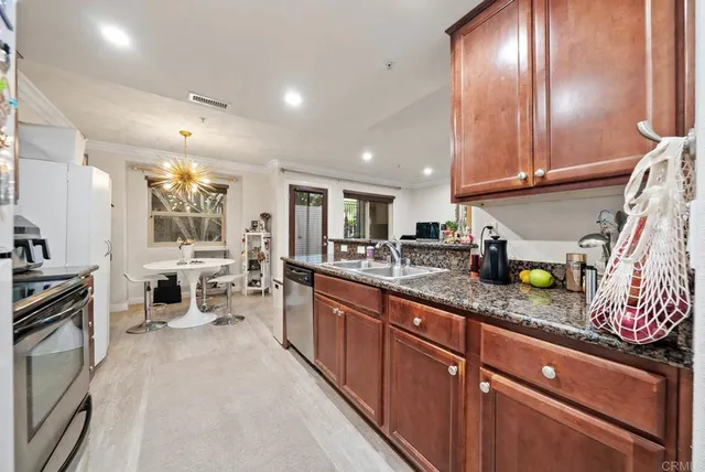 a large kitchen with granite countertop lots of counter space and a sink
